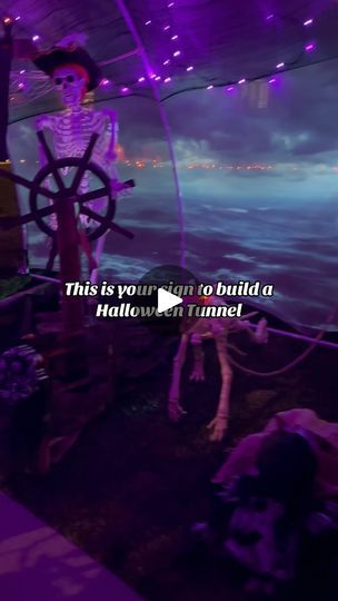 there is a fake skeleton on the deck of a boat in the water with purple lights behind it