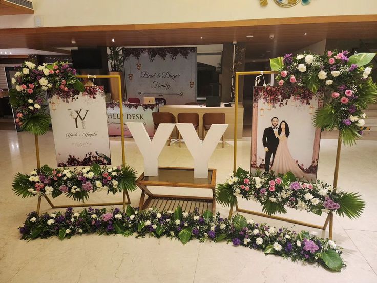 the letters y, v, and y are decorated with flowers in front of them