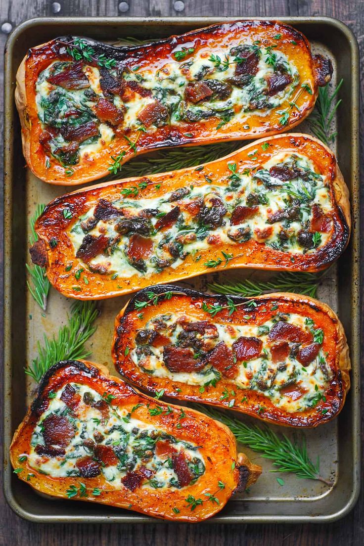 baked stuffed sweet potatoes with cheese and herbs on a baking sheet, ready to be eaten