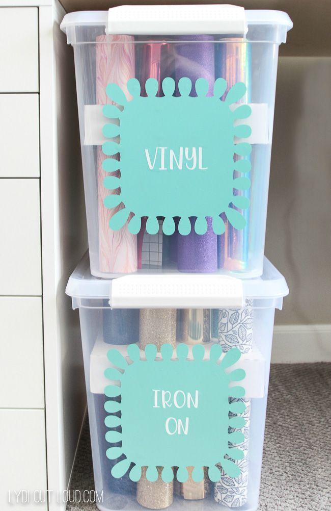 two plastic containers with labels on them are stacked next to each other in the closet