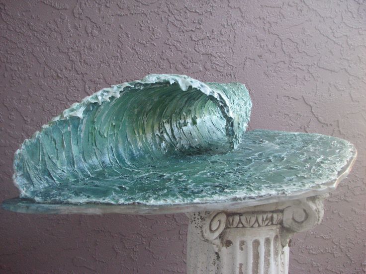 there is a sculpture that has a wave on it