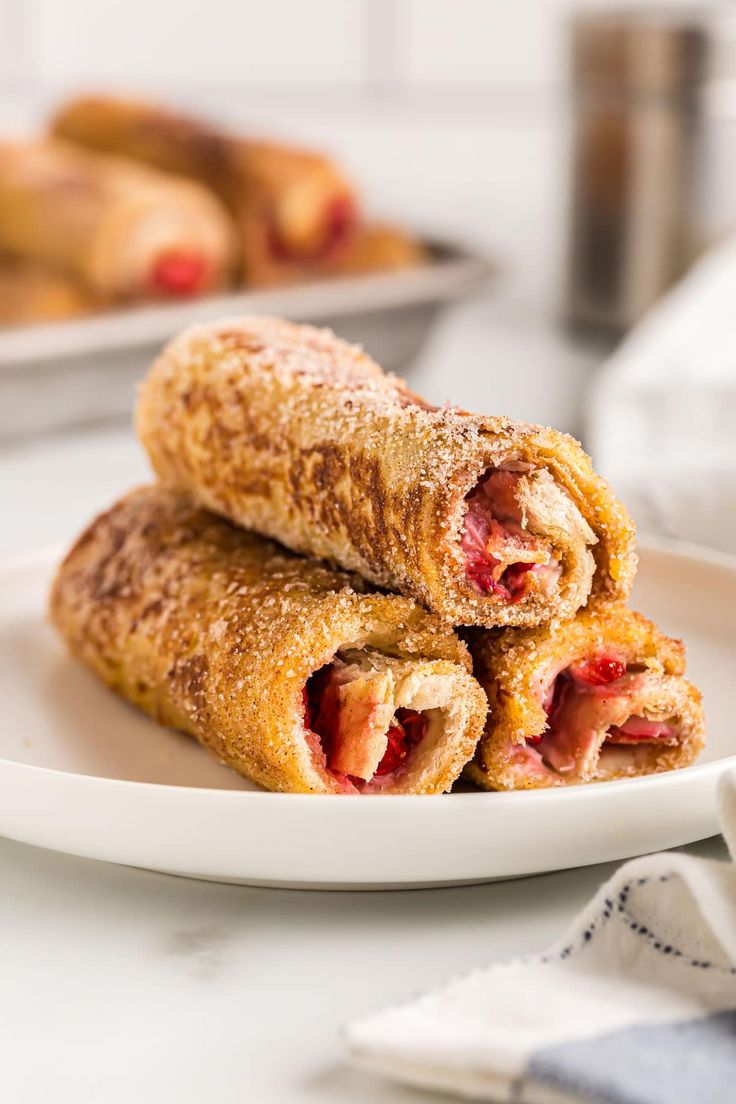 two pastries are stacked on a white plate