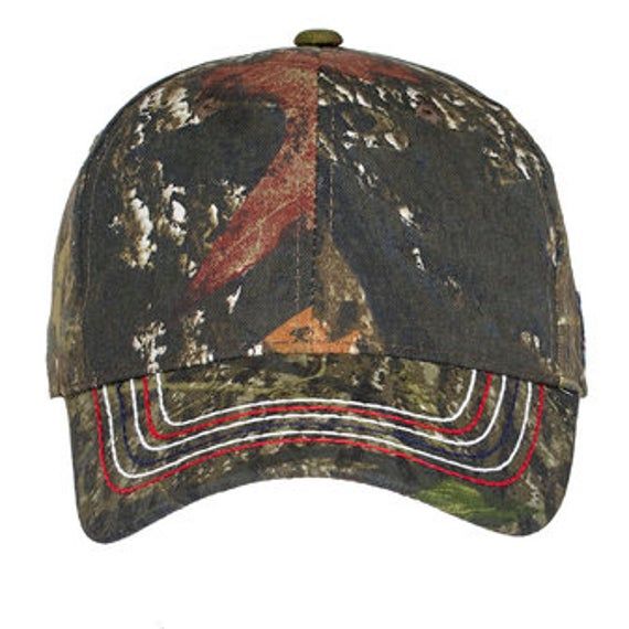 "CUSTOM Americana Contrast Stitch Camouflage Cap Colors Mossy Oak New Break-Up Realtree Xtra Product Description An embroidered flag label on the side plus heavy contrast stitching on the bill make this camo cap a true American classic. Fabric 60/40 cotton/poly canvas Structure Structured Profile Mid Closure Hook and loop Comfortable Custom Designs made for you!! Welcome To 1Of1Gifts Shop We have state-of-the-art equipment and embroidery materials and try to offer the best customer service to ma Camouflage Baseball Cap For Outdoor Activities, Military Camouflage Baseball Cap, Outdoor Camouflage Baseball Cap, Military Camouflage Snapback Hat With Curved Brim, Adjustable Camouflage Baseball Cap For Hunting, Military Style Camouflage Snapback With Curved Brim, Military Camouflage Snapback Baseball Cap, Military Style Camouflage Flat Cap, Military Style Dad Hat For Outdoor