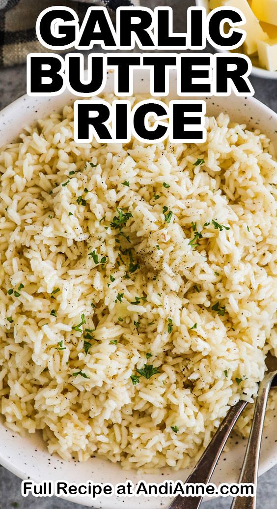 garlic butter rice in a white bowl with spoons on the side and text overlay that reads garlic butter rice