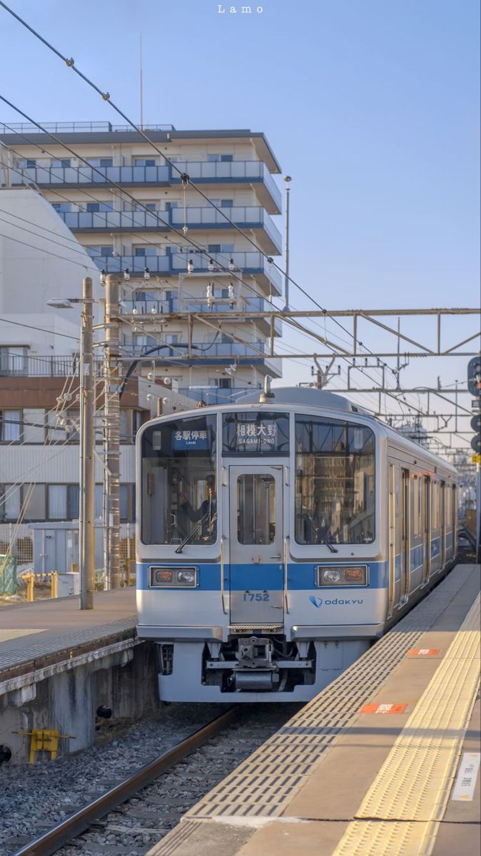 the train is pulling into the station to pick up passengers on it's way