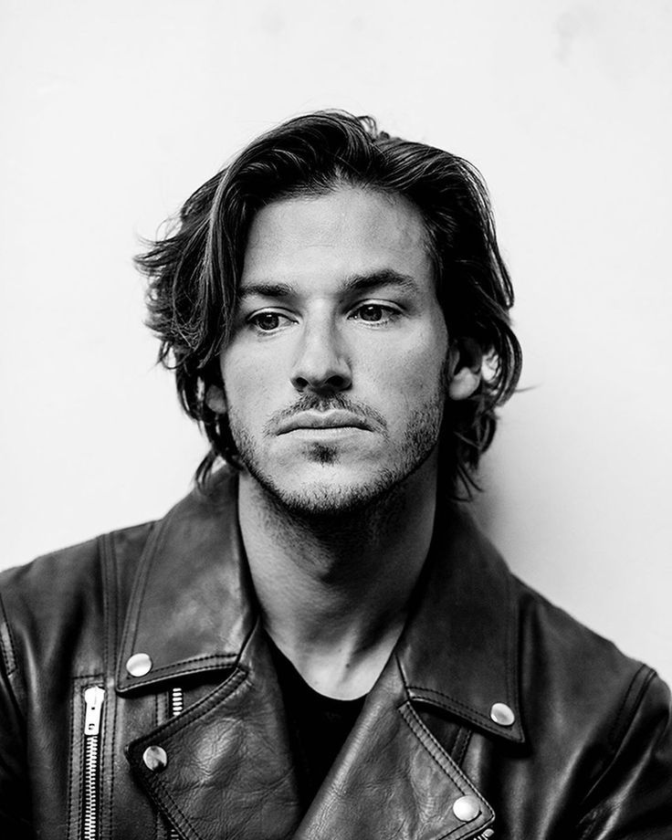 a black and white photo of a man in a leather jacket