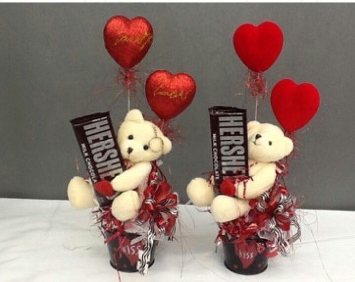 two teddy bears holding candy bars with hearts