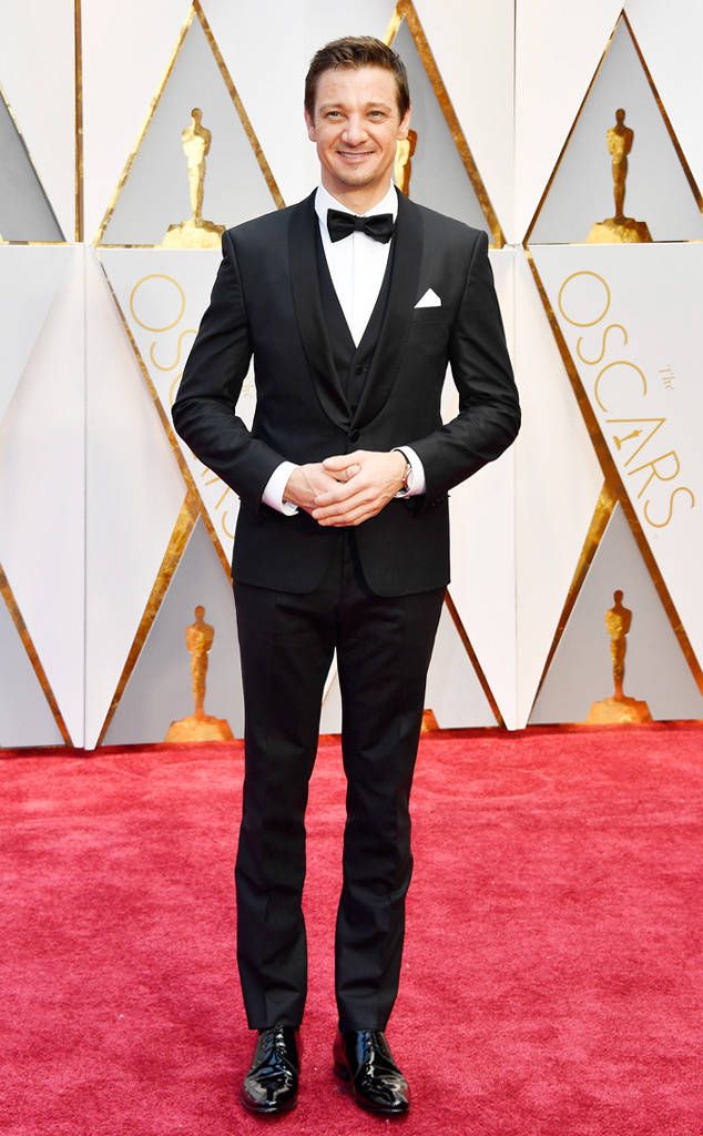 a man in a tuxedo on the red carpet at an oscars event