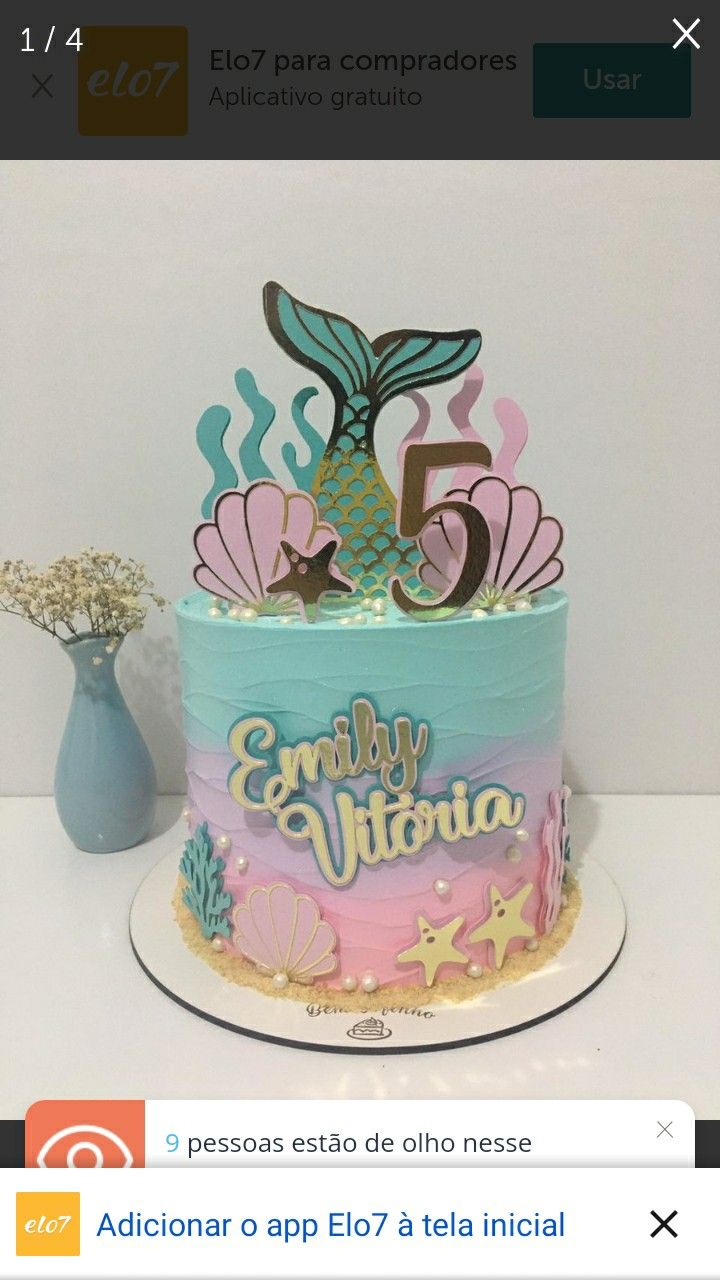 a birthday cake that is decorated with an ocean theme and the number five on top