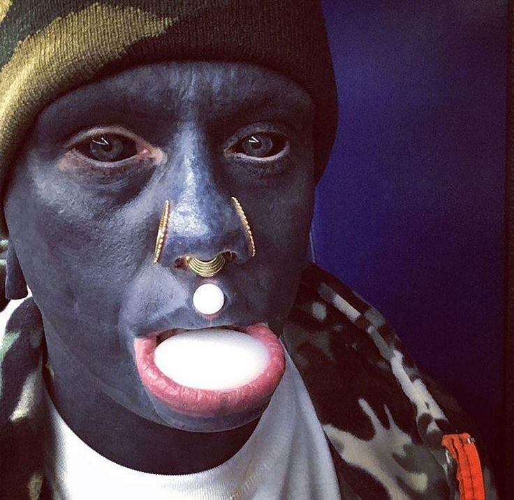 a man with black paint on his face and nose