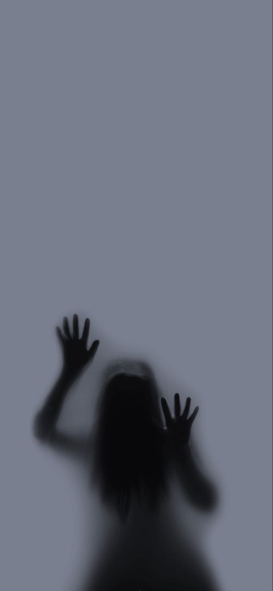 the shadow of a person holding their hands up in front of a gray background with black and white images