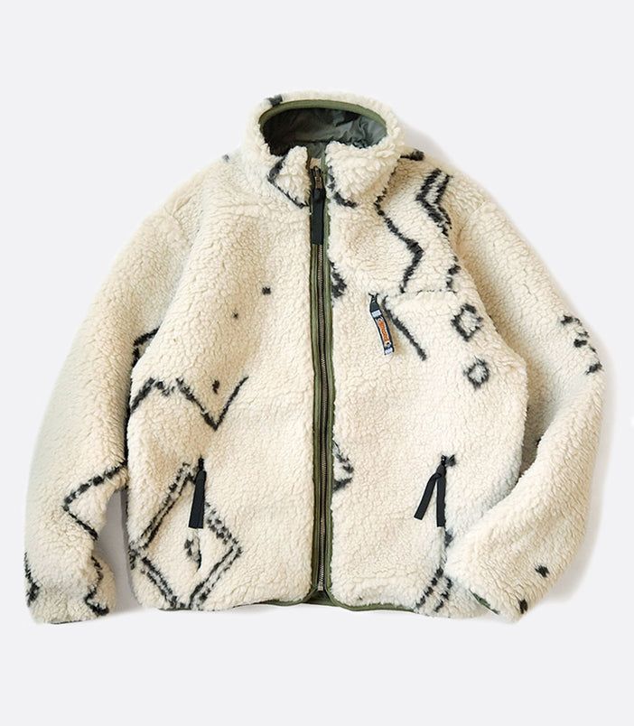 A reversible jacket with Beni Ourain patterned fleece on one side and a nylon shell on the other. Made of Fleece - 100% polyesterShell - 100% nylon Sizing Unisex sizing. Size 1 is most comparable to XS, size 2 to small, size 3 to medium, size 4 to large. Made by Made in Japan by Kapital Cheap Fleece Sweater For Winter, Luxury Quilted Urban Outerwear, Luxury Ralph Lauren Streetwear Outerwear, Luxury Urban Outerwear, White Sherpa Outerwear For Outdoor, Reversible Winter Outerwear For Outdoor, Reversible Winter Outerwear For Streetwear, Everyday Jacket, Guys Clothing Styles