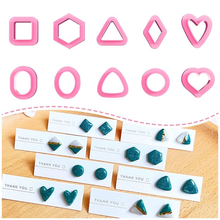 several different shapes and sizes of cookie cutters on a table with thank you note cards