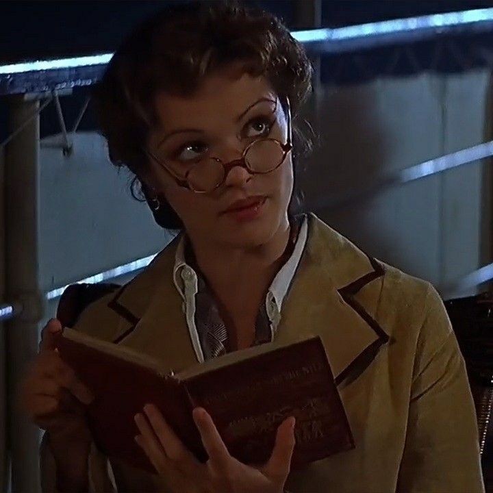 a woman wearing glasses and reading a book