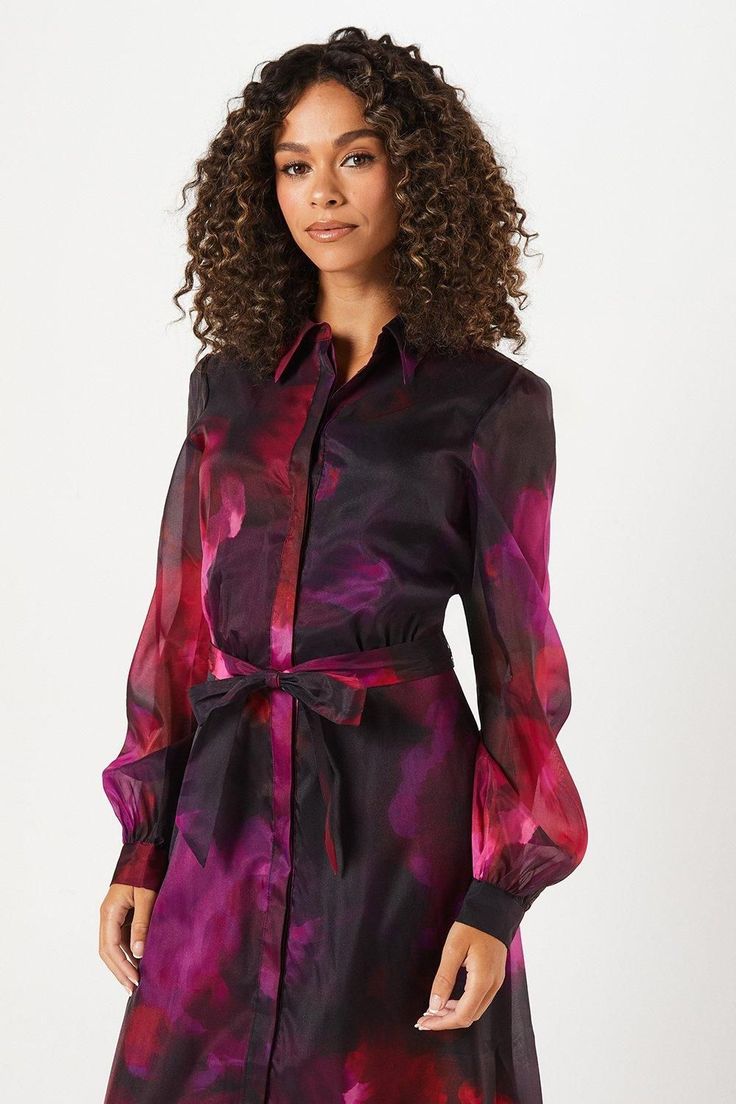 Striking floral organza fabric for a luxurious look
Elegant midi length perfect for formal occasions
Collared neckline adds a sophisticated touch
Long, billowing sleeves create a dramatic silhouette
Belted waist accentuates the figure beautifully
This enchanting shirt midi dress from Wallis radiates sophistication and glamour, ideal for the woman who loves to make a statement at formal events. The eye-catching floral organza fabric creates a mesmerising effect, while the midi length ensures a refined appearance suitable for a variety of occasions. Style this versatile piece with strappy heels and delicate jewellery for a wedding or pair it with elegant court shoes for a day at the races. The collared neckline and button-down front offer a classic shirt dress silhouette, while the volumin Dresses Tall, Dramatic Silhouette, Shirt Midi Dress, Delicate Jewellery, Organza Shirt, Day At The Races, Work Wear Outfits, Classic Shirt Dress, Petite Jumpsuit