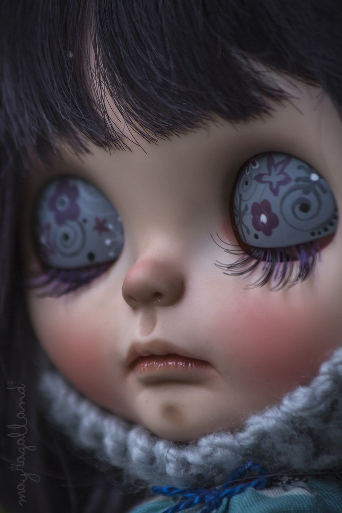 a close up of a doll with big eyes