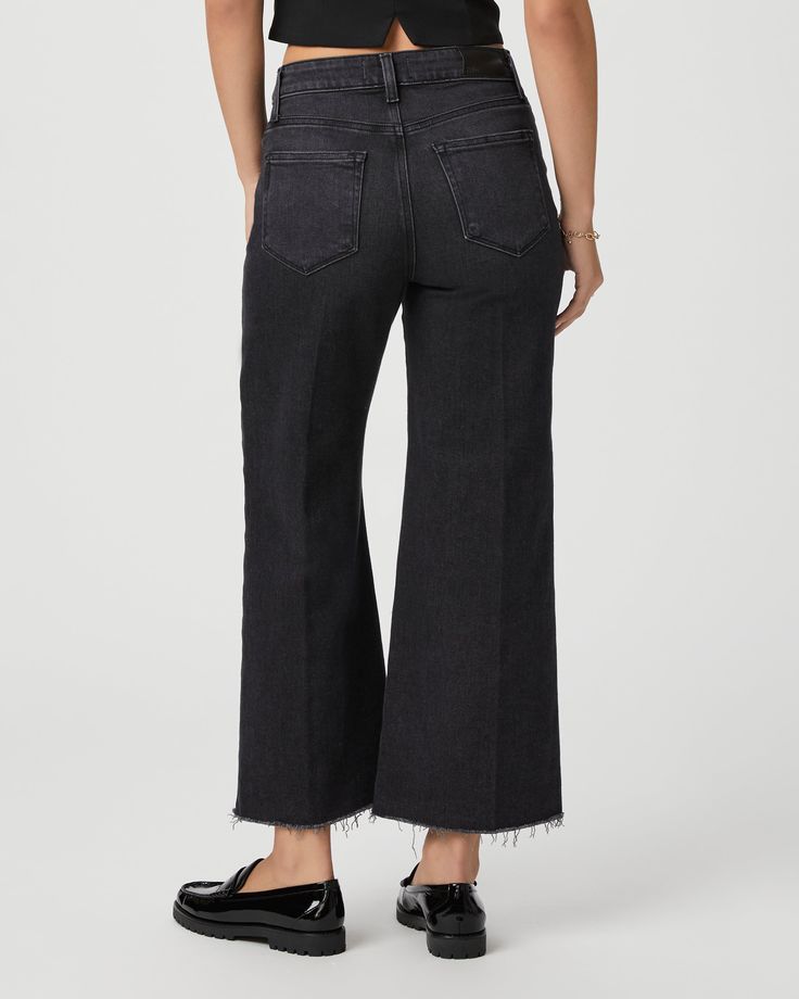 This modern high-waisted wide leg has an easy, relaxed fit and an ankle length silhouette. This style is cut from our PAIGE Vintage denim and comes in a vintage black wash with whiskering, fading, and a raw hem. PAIGE Vintage takes all of the work out of breaking in your favorite pair of vintage jeans. We've combined the comfort of stretch with everything you love about authentic vintage denim to create super soft jeans that feel perfectly lived-in from the very first wear. | Anessa Wide Leg Jea Black High-rise Cropped Jeans For Work, Black High Rise Cropped Jeans For Work, Black Wide Leg Cropped Jeans For Work, Chic Wide Leg Flare Jeans In Washed Black, Chic Wide Leg Washed Black Flare Jeans, Black Wide Leg Cropped Jeans With Five Pockets, Black Wide Leg Pants With Five Pockets, High Rise Washed Black Flare Jeans For Work, Washed Black Cropped Jeans For Work