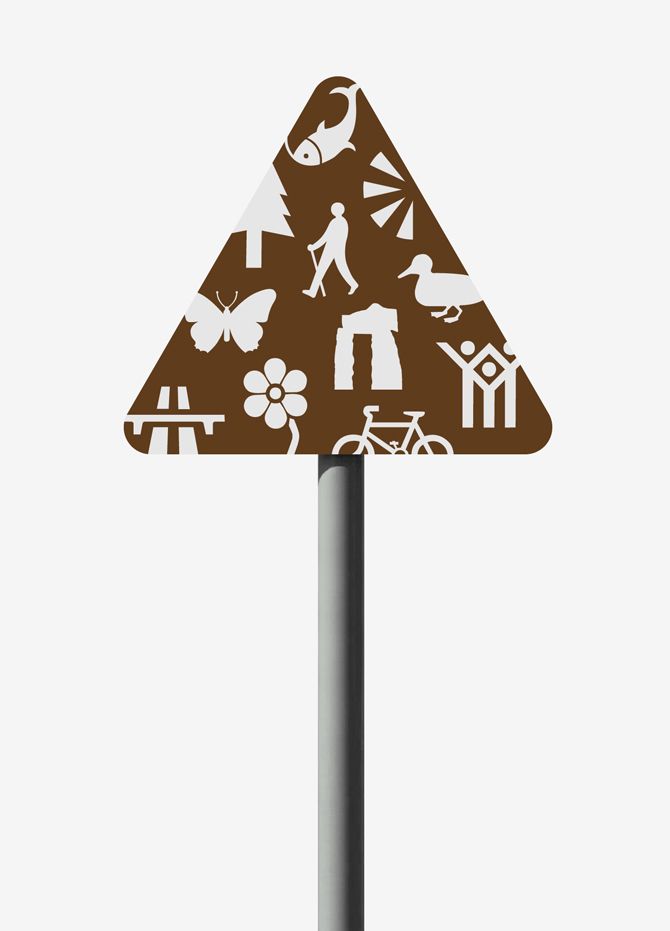 a brown and white street sign sitting on top of a metal pole with symbols all over it