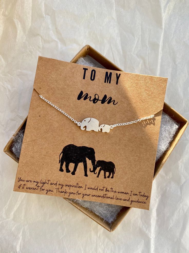 an elephant necklace with two elephants on it