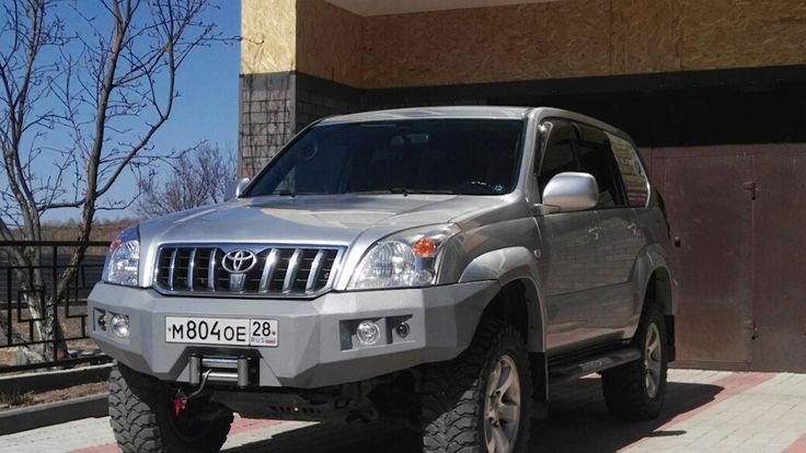 a silver suv parked in front of a building