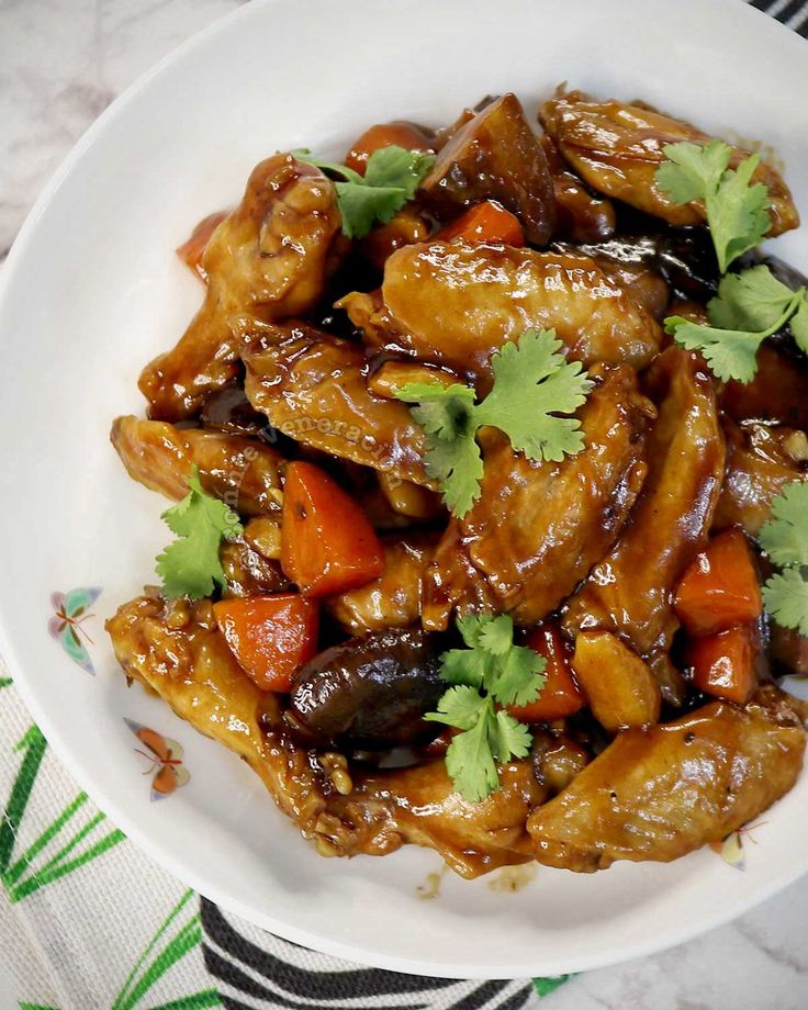 a white bowl filled with chicken and vegetables