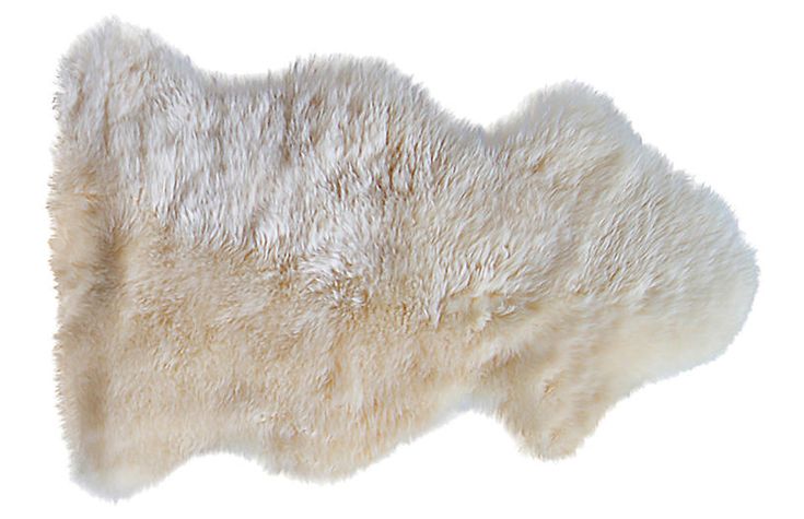 the back side of a sheepskin rug on a white background