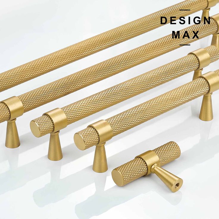 four golden metal rods with the words design max on them