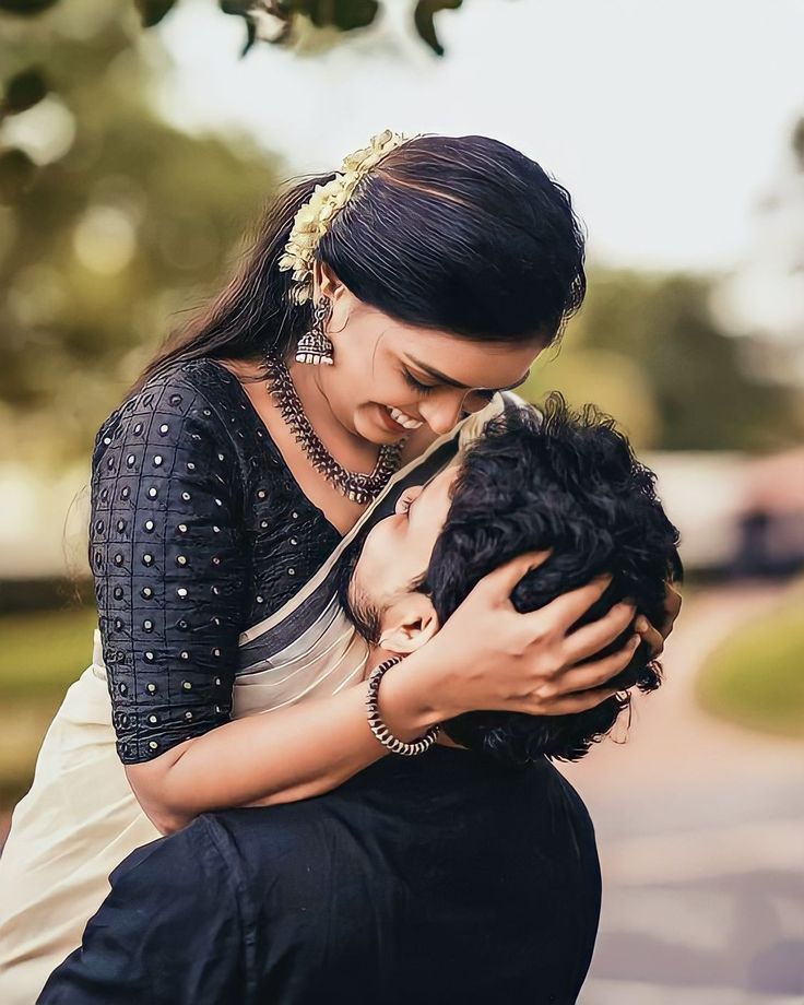 a woman holding a man in her arms