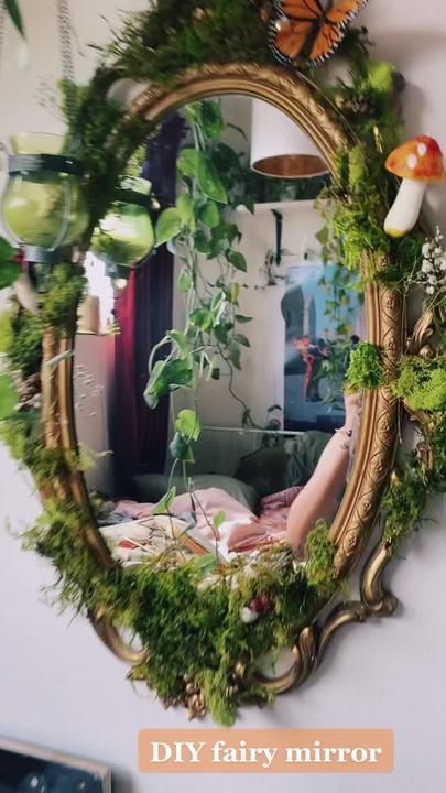 a mirror that has plants on it in front of a wall with the words diy fairy mirror