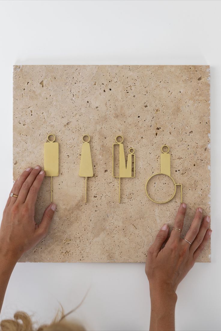 a woman is placing pins on the wall