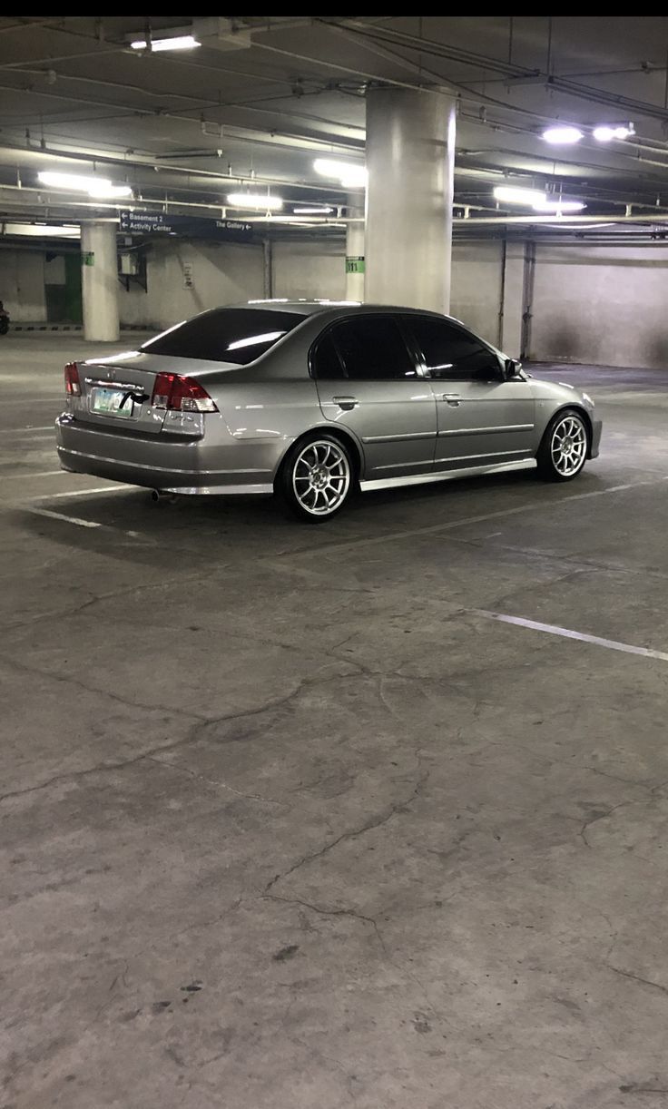 a silver car parked in a parking garage