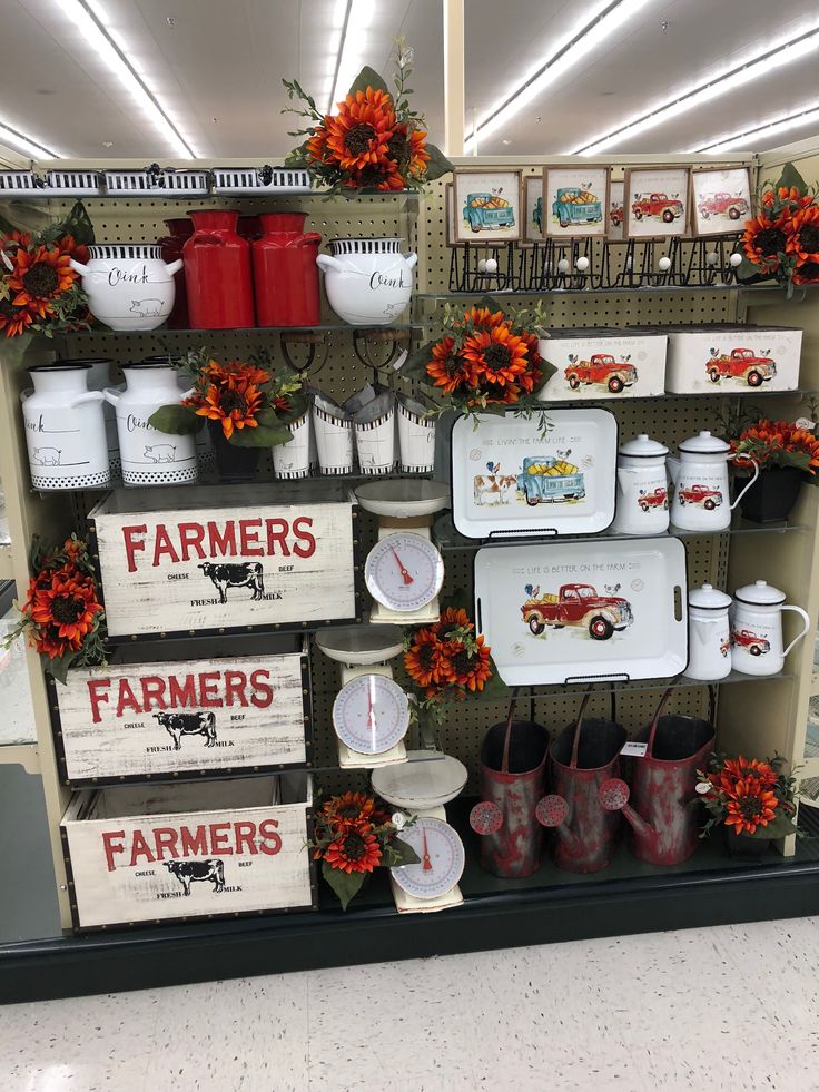 there are many farm related items displayed on the shelves in this store, including plates and mugs