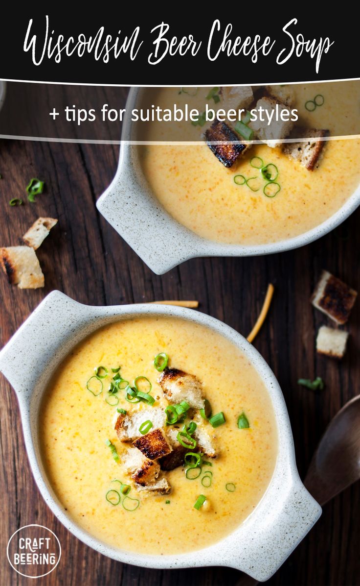 two white bowls filled with soup and topped with croutons, scallions and cheese