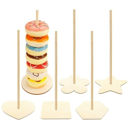 a stack of doughnuts on top of each other in front of wooden picks