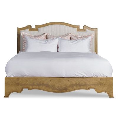 a bed with white sheets and pillows on top of it's headboard, in front of a white background