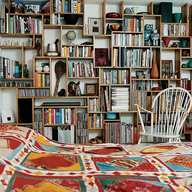 an image of a room with bookshelves on the wall and other things in it