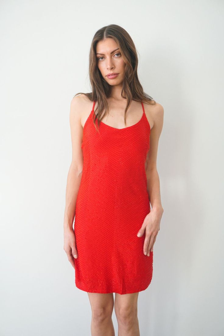 Shine on. This luxurious & stunning slip dress is mini-length and is fully hand-beaded by women artisans in Bali. Perfect for a night out or special occasion, you'll be sure to dance 'til dawn in this dress. Features adjustable back crisscross straps and an invisible back zipper. Also available in White. Ethically handcrafted from luxurious sustainable fabrics certified Oeko Tex Standard 100.1% of your order funds regenerative carbon offsets How it Fits Product Details Fabric & Care Fits true to Evening Sequin Mini Dress With Beaded Straps, Evening Mini Sequin Dress With Beaded Straps, Fitted Mini Sequin Dress With Beaded Straps, Glamorous Summer Evening Flapper Dress, Summer Mini Flapper Dress With Sequins, Fitted Summer Flapper Dress For Evening, Fitted Summer Flapper Dress For Cocktail, Glamorous Summer Sequin Dress With Beaded Straps, Fitted Sequin Dress With Beaded Straps For Summer