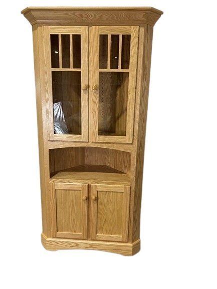 a wooden corner cabinet with glass doors