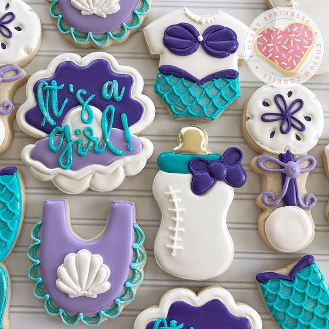 decorated cookies are displayed on a table