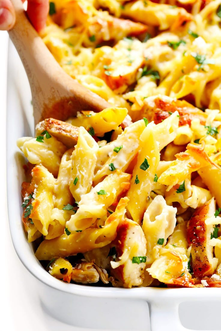 a casserole dish filled with pasta and chicken