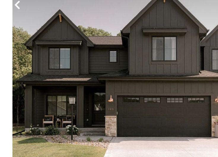 a large house with two garages in the front and one on the other side