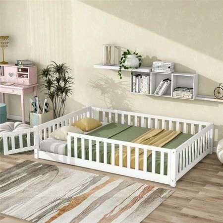 there is a white baby bed in the room with bookshelves on the wall