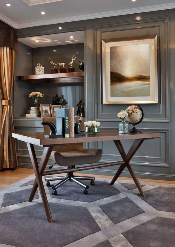 a home office with gray walls and carpet