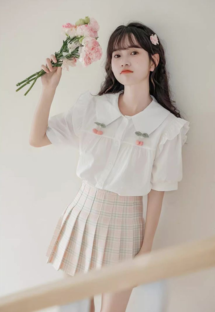 Button up shirt with a peter pan collar, short puff sleeves, frilly shoulders and pin-on cherries. S: 13.5" across shoulders, 39" chest, 23" lengthM: 14" across shoulders, 40.5" chest, 23" lengthL: 14.5" across shoulders, 42" chest, 23" length Spring Preppy Short Sleeve Tops, Preppy Short Sleeve Tops For Spring, Cute Doll Collar Summer Blouse, Cute Doll Collar Blouse For Summer, Casual Shirt With Peter Pan Collar For Spring, Cute Collared Blouse With Ruffles, White Spring Blouse For School, White School Blouse For Spring, White Blouse For School In Spring