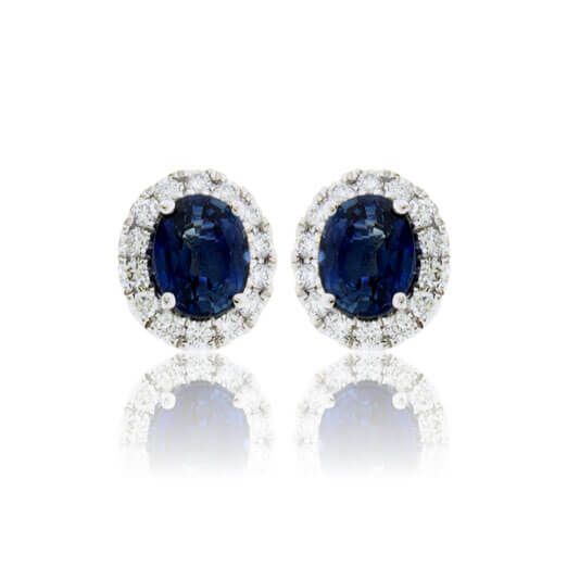 Oval Sapphire with Diamond Halo Stud Earrings - Park City Jewelers Formal Gia Certified Oval Earrings, Classic Halo Setting Earrings For Formal Occasions, Classic Formal Earrings With Halo Setting, Timeless Formal Diamond Earrings With Halo Detail, Timeless Formal Diamond Earrings With Halo, Formal Timeless Halo Diamond Earrings, Formal Sapphire Diamond Earrings With Prong Setting, Oval Sapphire Diamond Earrings For Anniversary, Sapphire Diamond Earrings With Halo Design