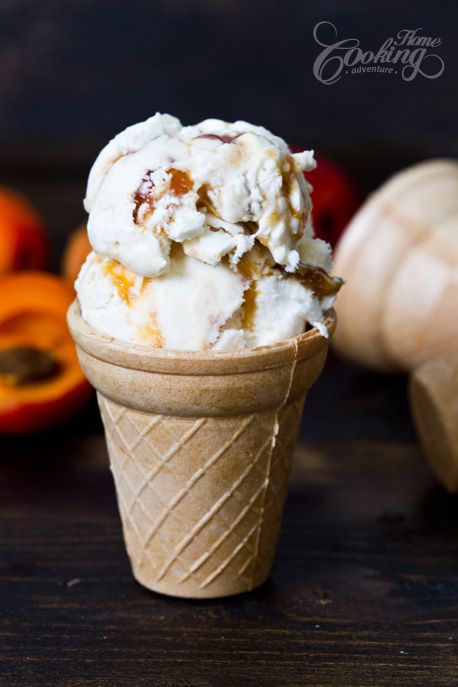 two scoops of ice cream sitting on top of an orange peel next to some fruit