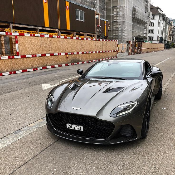 a black sports car is parked on the street