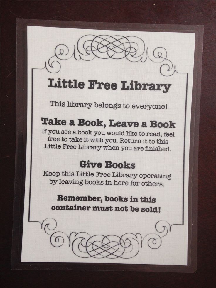 a little free library sign with instructions for the book to be taken home from school