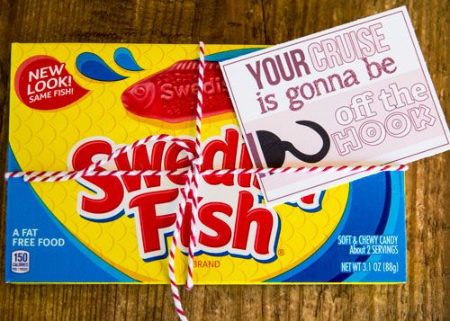 a candy bar wrapped in twine on top of a wooden table next to a sign