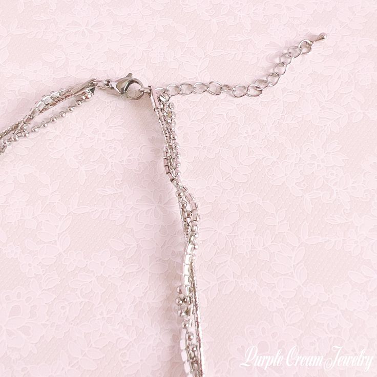 A necklace with a ribbon and heart motif zirconia pendant top♡

 This is a unique chain that consists of three types of chain: snake, ball, and rhinestone.

 Comes with a long adjuster so you can adjust the length.



 Color: Silver

 Chain length: approx. 40cm (+ 5cm adjuster)

 Pendant size: approx. 1.5cm x 1.1cm

 Material: Zinc alloy



 As this is an imported product, please refrain from purchasing if you are sensitive or looking for perfection. Adjustable Metal Charm Necklaces For Wedding, Adjustable Chain Necklace For Anniversary, Adjustable Rhinestone Dangle Necklace As A Gift, Adjustable Charm Necklaces With Lobster Clasp For Party, Adjustable Dangle Rhinestone Necklace For Gift, Adjustable Party Charm Necklaces With Lobster Clasp, Silver Rhinestone Necklace With Adjustable Chain For Anniversary, Anniversary Crystal Rhinestone Necklace With Adjustable Chain, Wedding Rhinestone Necklace With Adjustable Chain